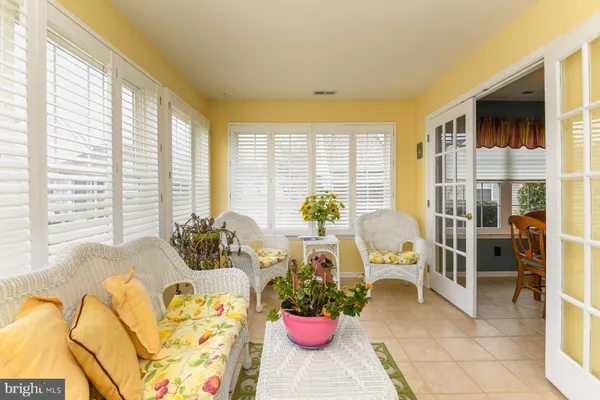 a living room filled with furniture and a large window