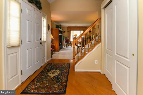 a view of entryway with wooden floor and stairs