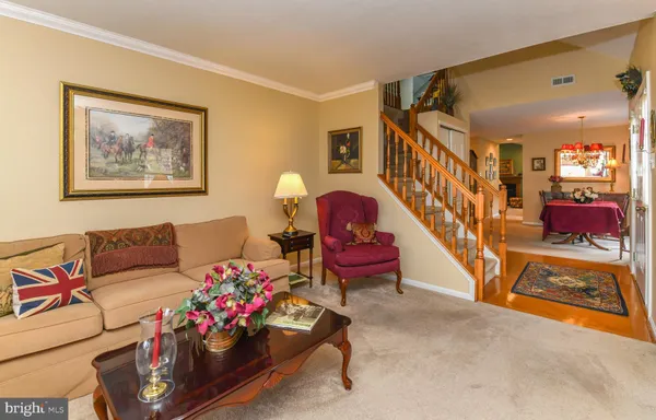 a living room with furniture and a baby crib