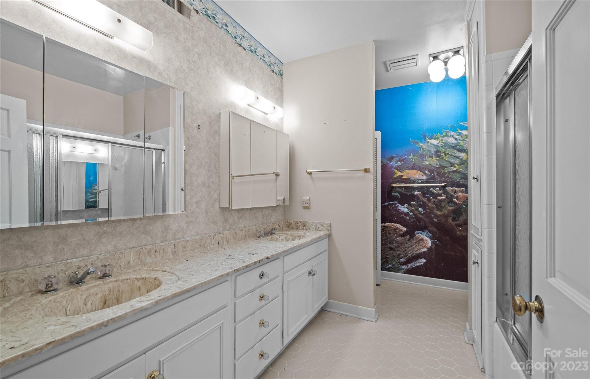 3424 Colony Road Charlotte, NC 28211 - Photo 40 of 48 a bathroom with a granite countertop sink a shower and a mirror