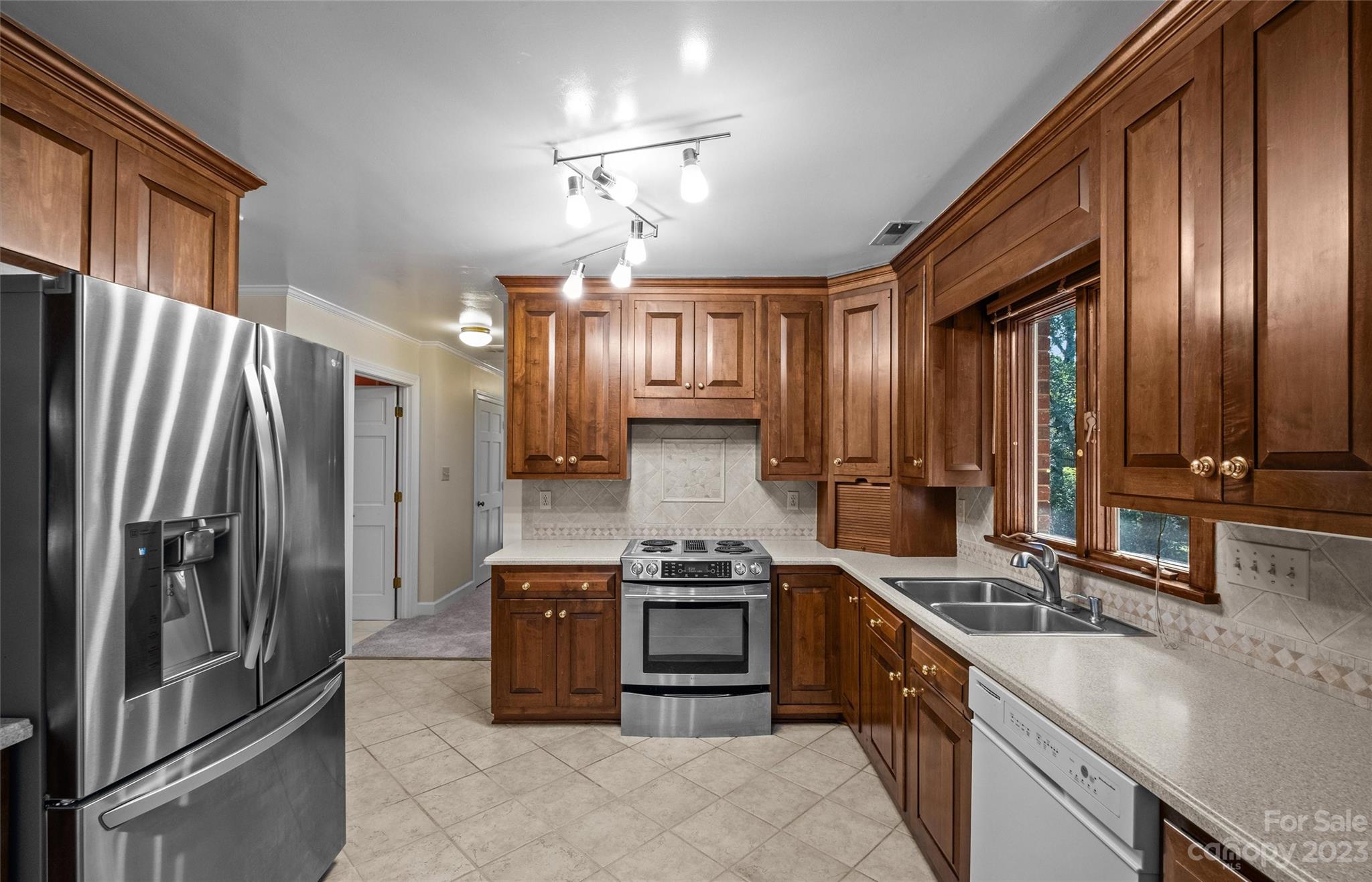 3424 Colony Road Charlotte, NC 28211 - Photo 8 of 48 a kitchen with stainless steel appliances granite countertop a refrigerator a stove and a sink with cabinets