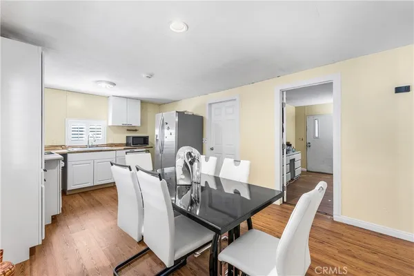 a view of a dining room with furniture and wooden floor