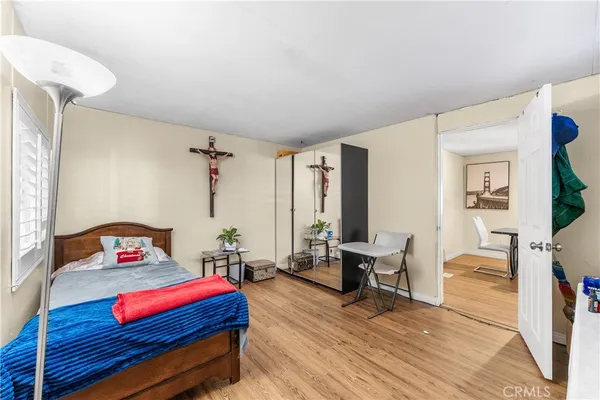 a bedroom with furniture and a wooden floor