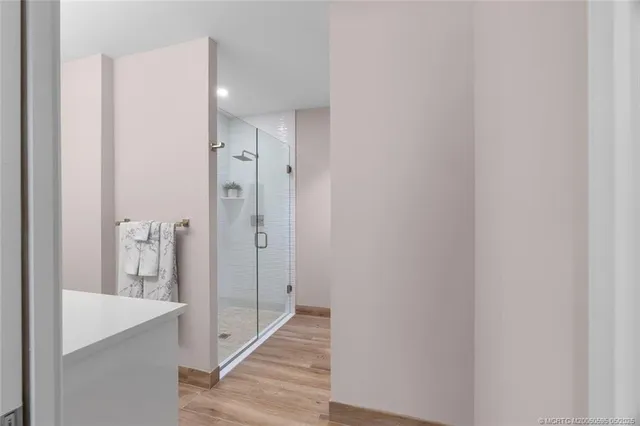 a bathroom with a sink a shower and a mirror