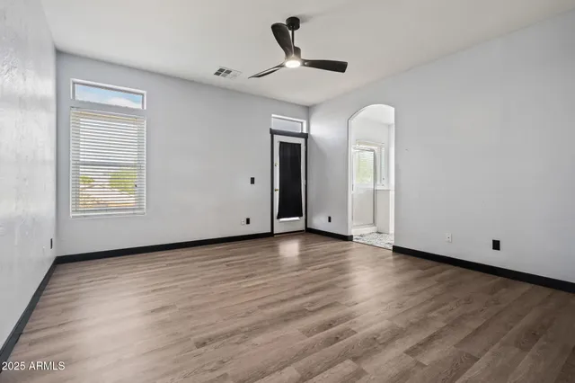a view of a livingroom with wooden floor and window