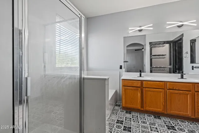 a spacious bathroom with a mirror sink and toilet