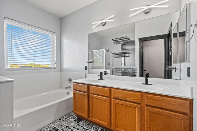 a bathroom with a tub sink and mirror