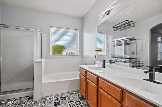 a bathroom with a sink a bathtub and a shower