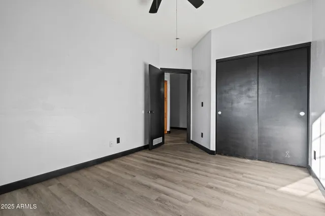 a view of an empty room with wooden floor