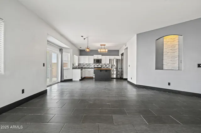 a view of a kitchen with furniture and an empty room