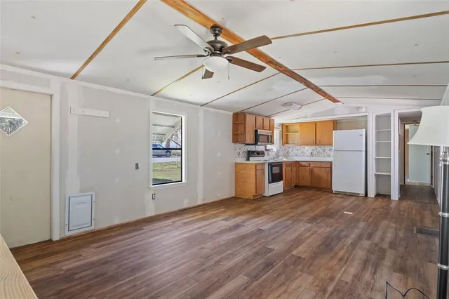 a view of a kitchen with furniture and wooden floor