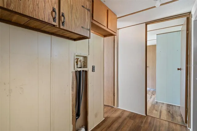 a view of a hallway with wooden floor and entryway