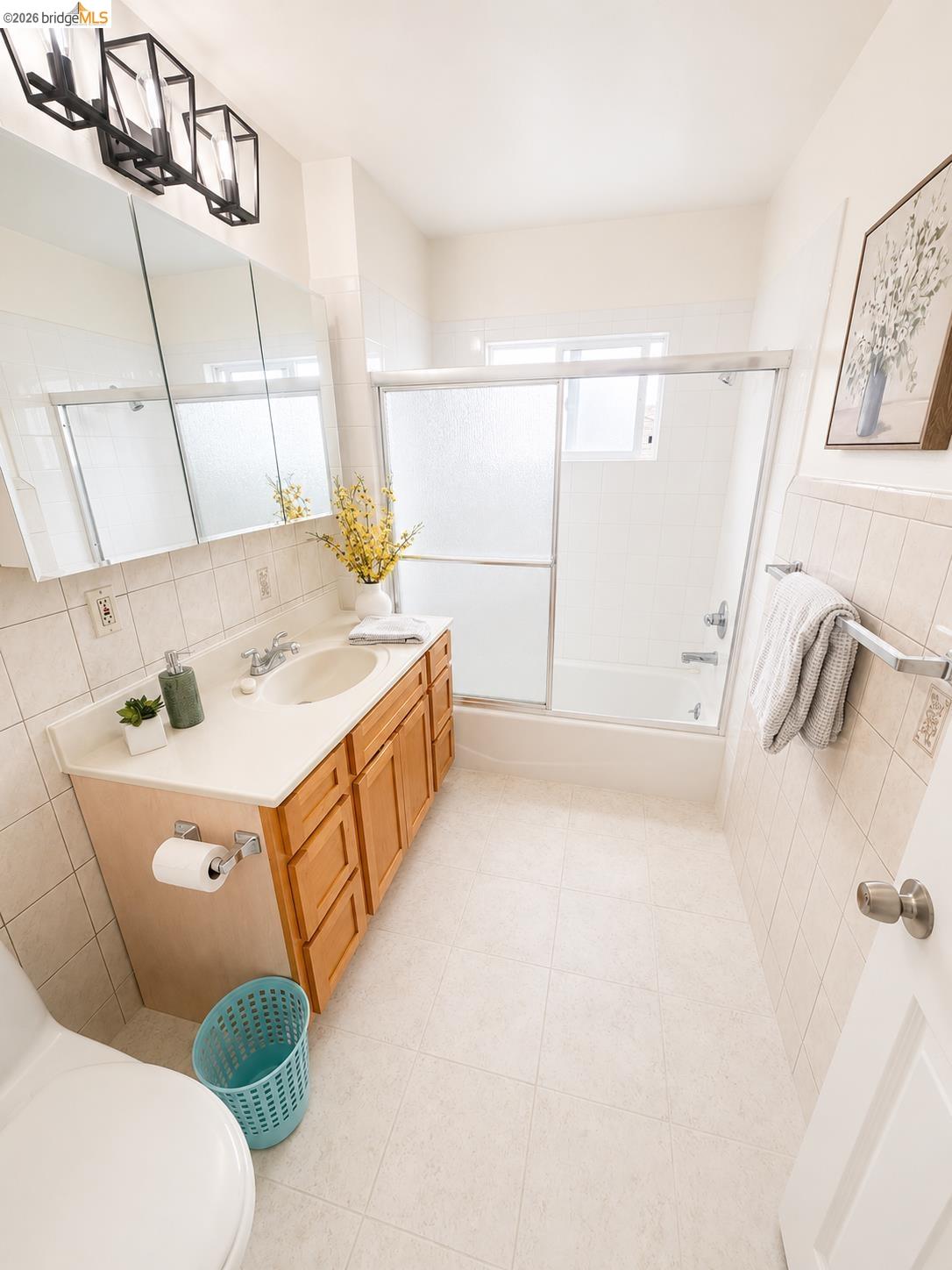 810 Pierce Street Albany, CA 94706 - Photo 6 of 25 Bathroom featuring a single vanity with wood cabinetry, a built-in sink, and a light-colored countertop