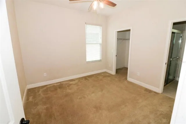 an empty room with windows and closet