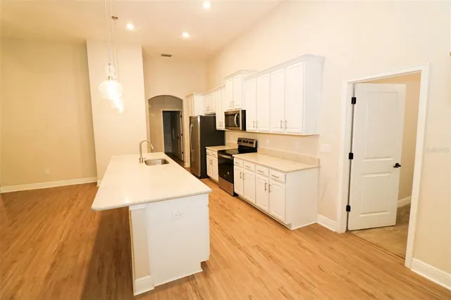 a kitchen with a sink a stove and a refrigerator
