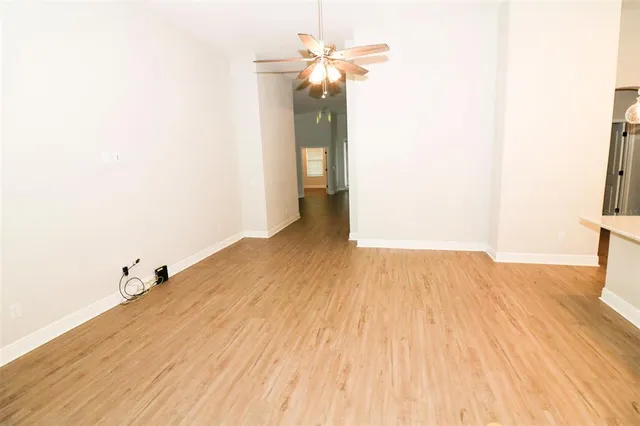 a view of a room with wooden floor