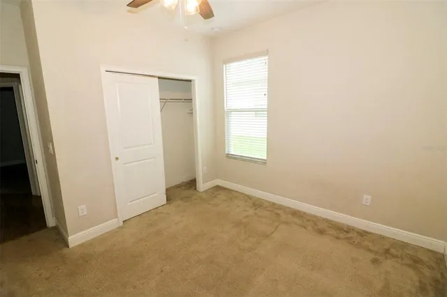 an empty room with windows and closet