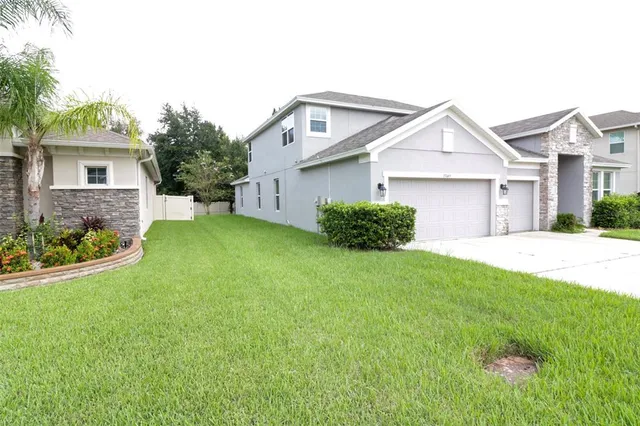 a front view of a house with a yard and garage