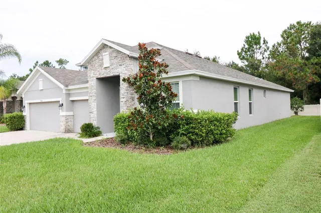 a front view of house with yard and green space