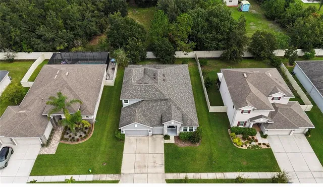 an aerial view of a house with garden space pool patio and outdoor seating