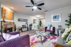 a living room with furniture fireplace and window