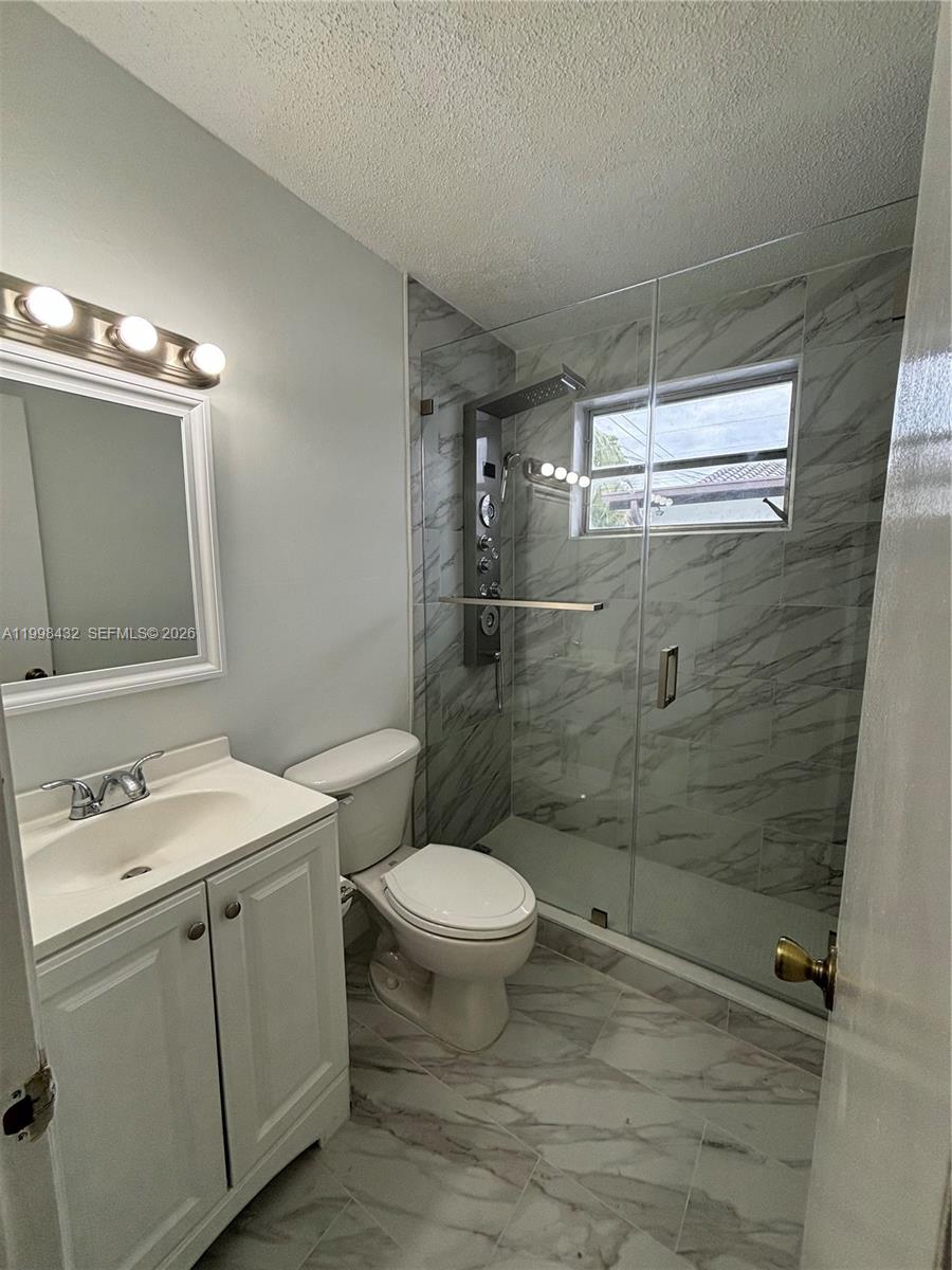 5011 Southwest 5th Street Miami, FL 33134 - Photo 4 of 5 a bathroom with a sink toilet and shower
