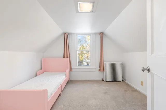 a room with a bed and a window