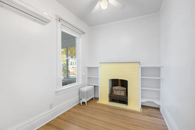 a view of a livingroom with a fireplace and window