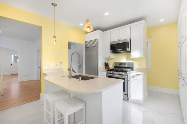 a kitchen that has a sink and a stove top oven
