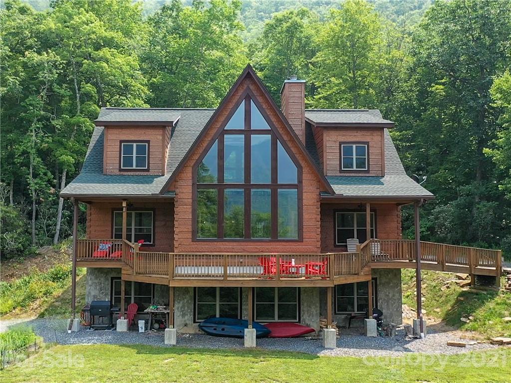 a view of a house with pool and sitting area