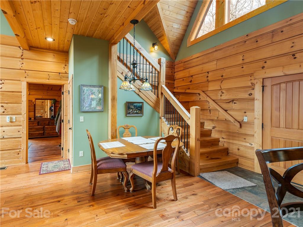 263 Mount Mitchell Drive Burnsville, NC 28714 - Photo 15 of 39 a view of a patio with table and chairs with wooden floor and fence