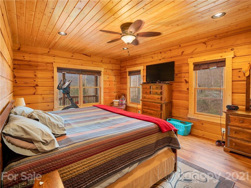 263 Mount Mitchell Drive Burnsville, NC 28714 - Photo 17 of 39 a bedroom with a bed and wooden floor