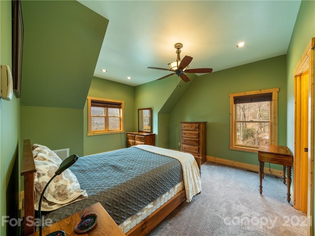 263 Mount Mitchell Drive Burnsville, NC 28714 - Photo 23 of 39 a bedroom with a bed and a dresser next to a window