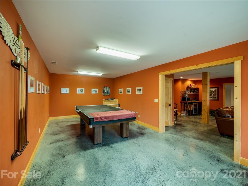 263 Mount Mitchell Drive Burnsville, NC 28714 - Photo 28 of 39 a room with furniture and a chandelier