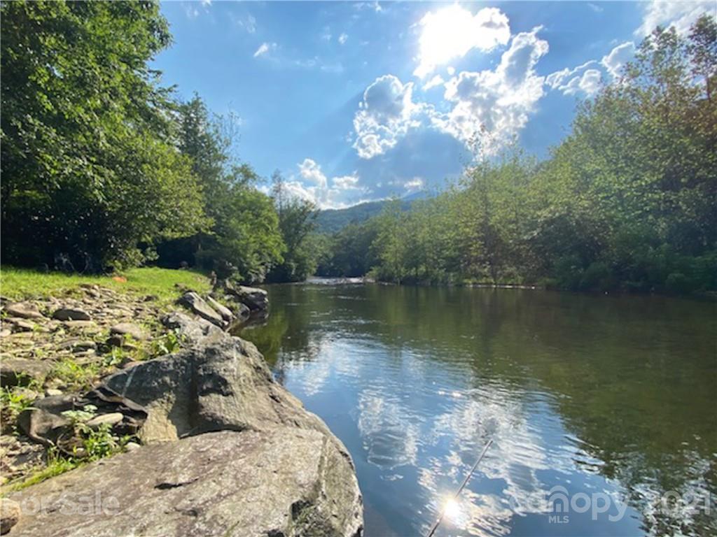 263 Mount Mitchell Drive Burnsville, NC 28714 - Photo 34 of 39 a view of a lake with a tree in the background