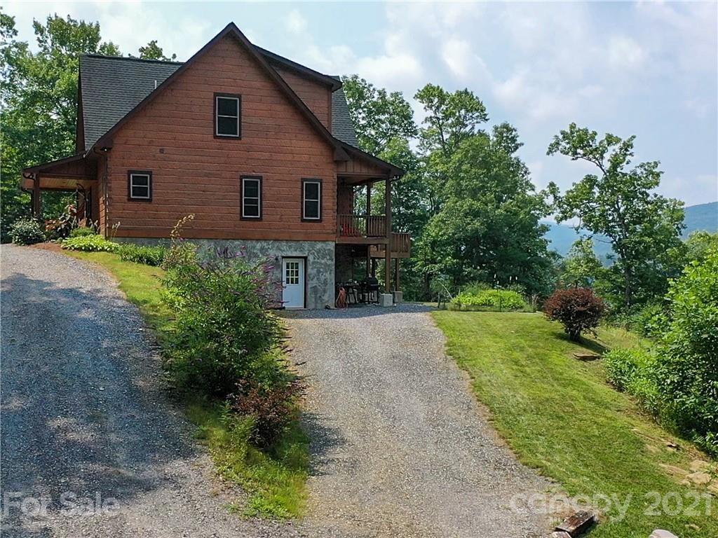 263 Mount Mitchell Drive Burnsville, NC 28714 - Photo 5 of 39 a view of a house with yard and a garden