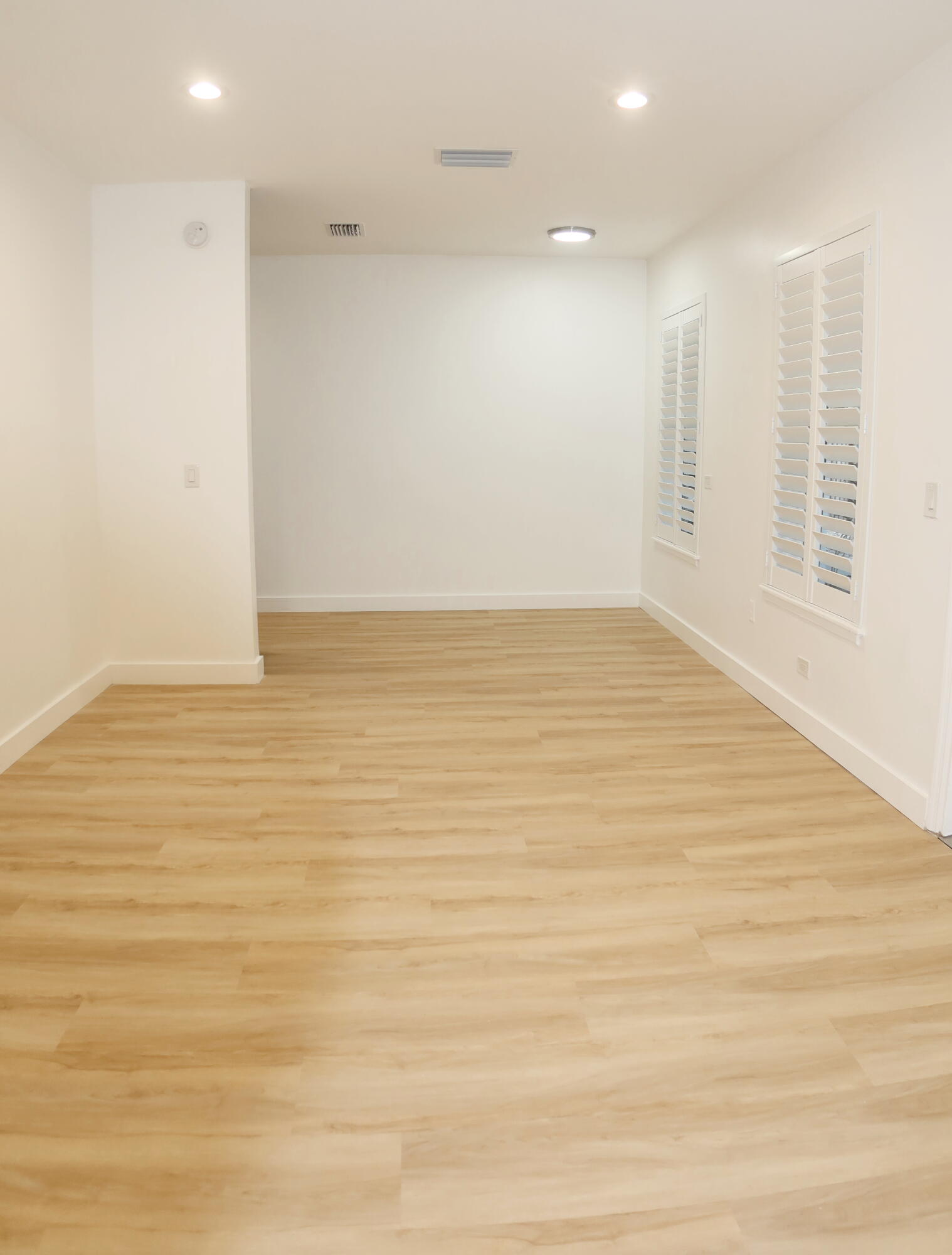 614 Palm Street, Unit 1 West Palm Beach, FL 33401 - Photo 14 of 17 a view of an empty room with wooden floor and a window