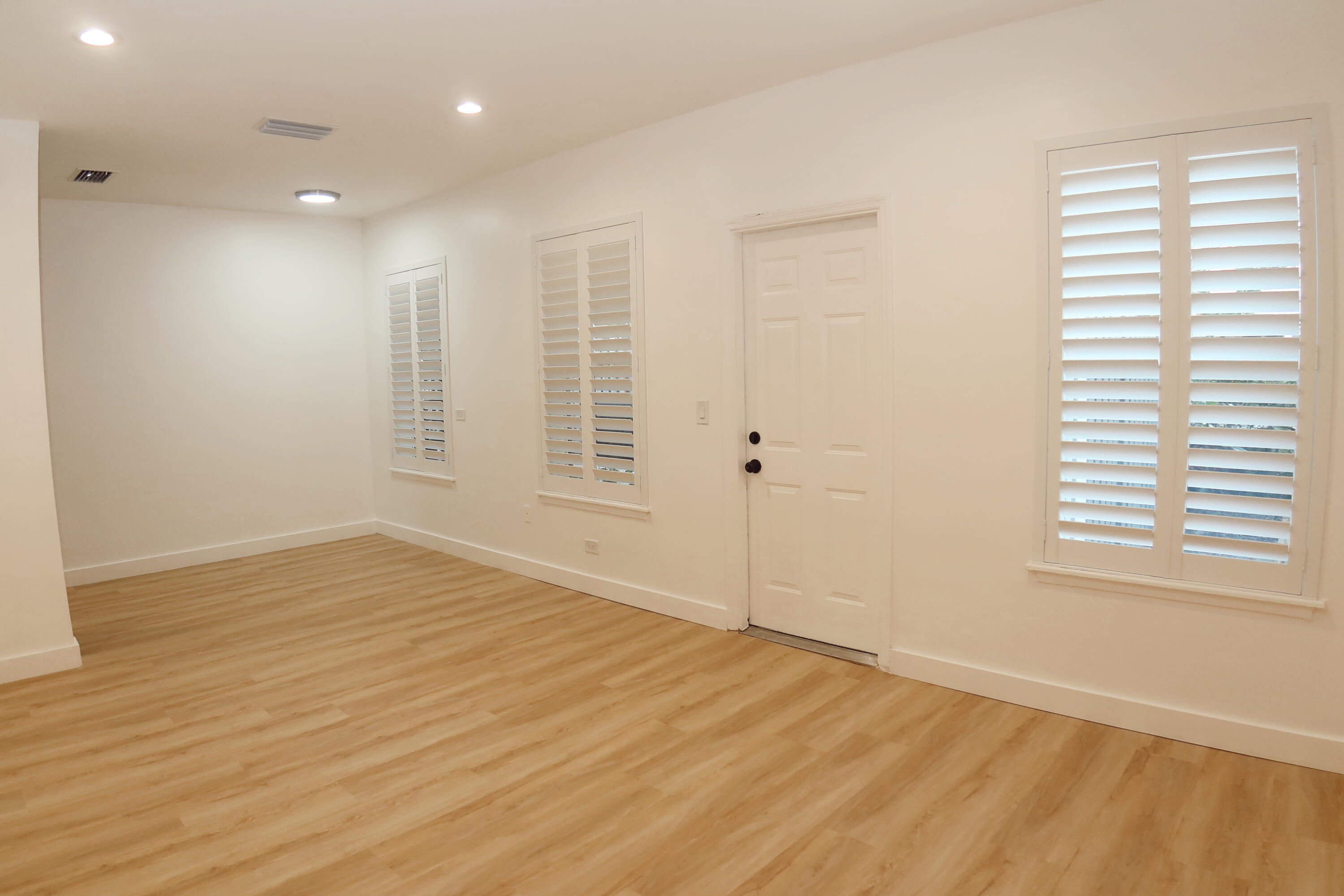 614 Palm Street, Unit 1 West Palm Beach, FL 33401 - Photo 3 of 17 a view of an empty room with wooden floor and a window