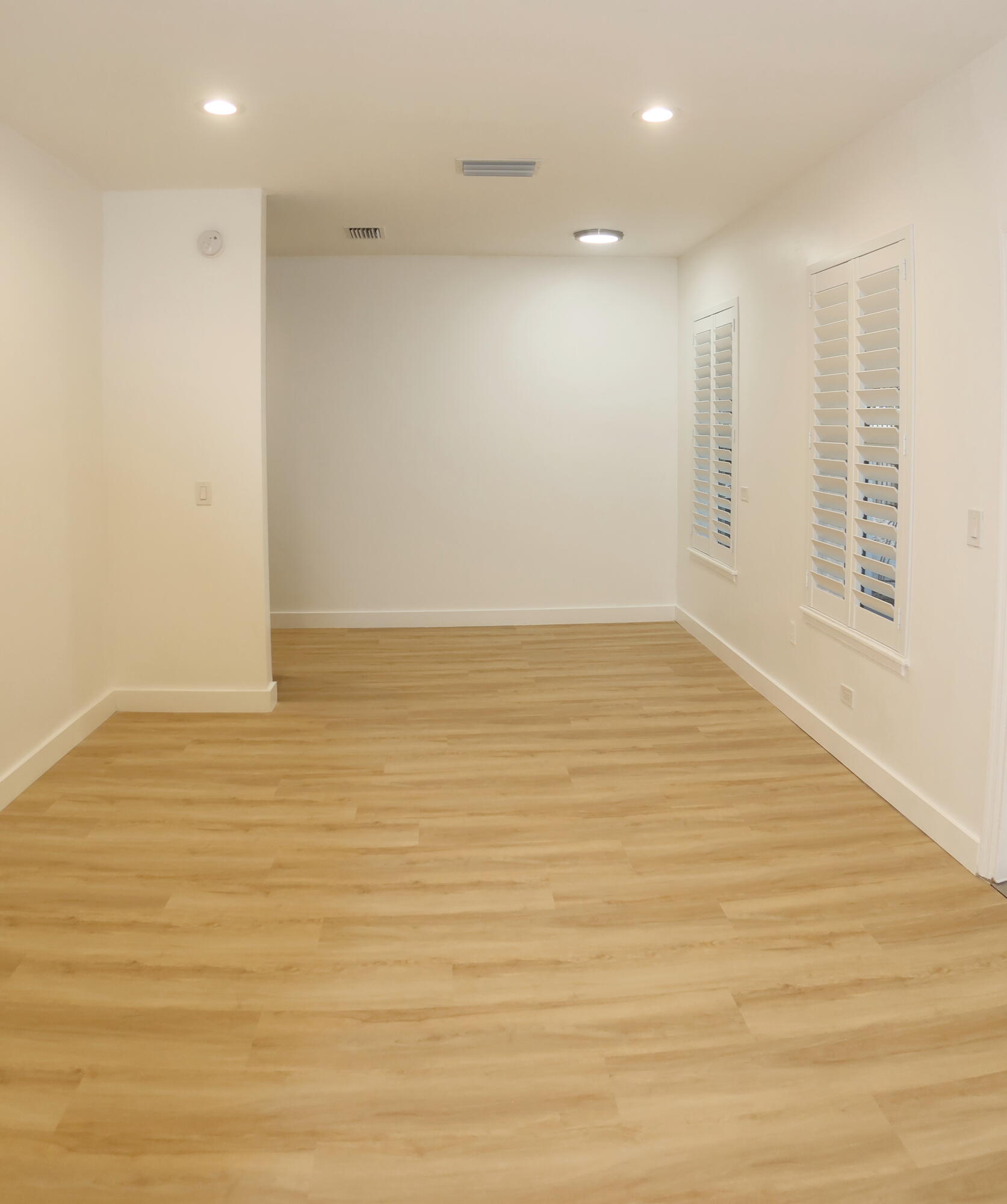 614 Palm Street, Unit 1 West Palm Beach, FL 33401 - Photo 4 of 17 a view of an empty room with wooden floor and a window