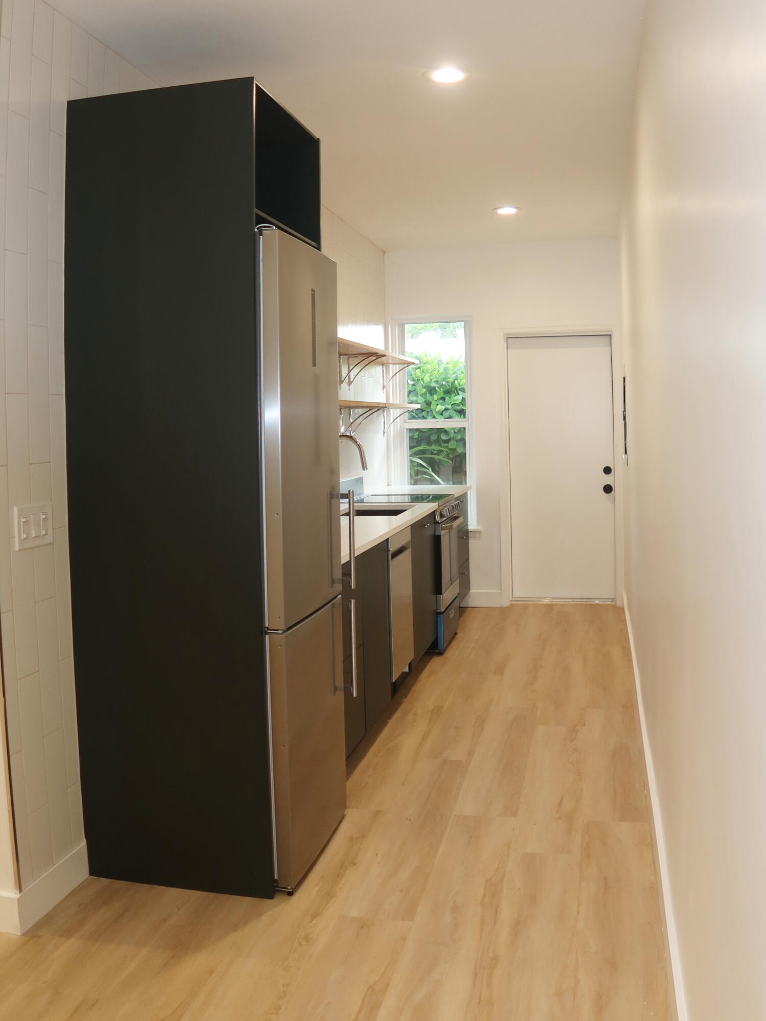 614 Palm Street, Unit 1 West Palm Beach, FL 33401 - Photo 5 of 17 a kitchen with stainless steel appliances a refrigerator and a sink