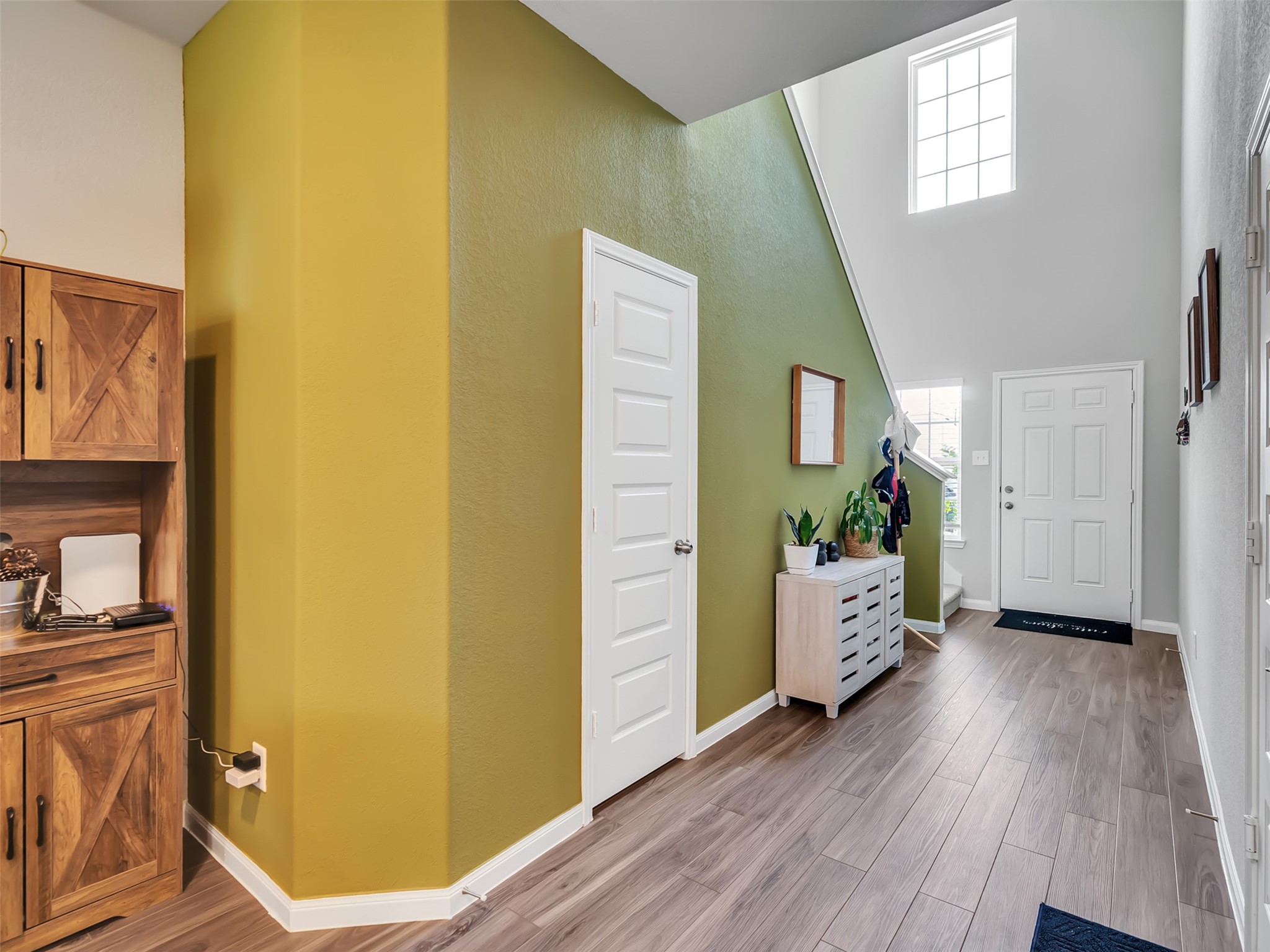 2416 Bluefish Court Conroe, TX 77384 - Photo 35 of 45 a view of a hallway with wooden floor and furniture