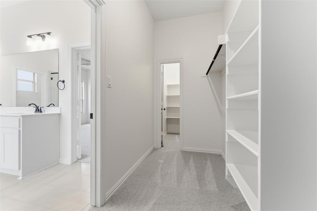 114 Brandywine Trail Rhome, TX 76078 - Photo 19 of 27 a view of a hallway with closet and racks