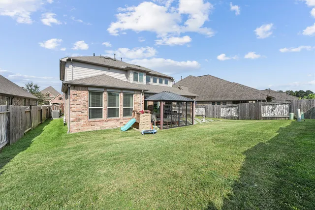 a view of a house with a yard and sitting area