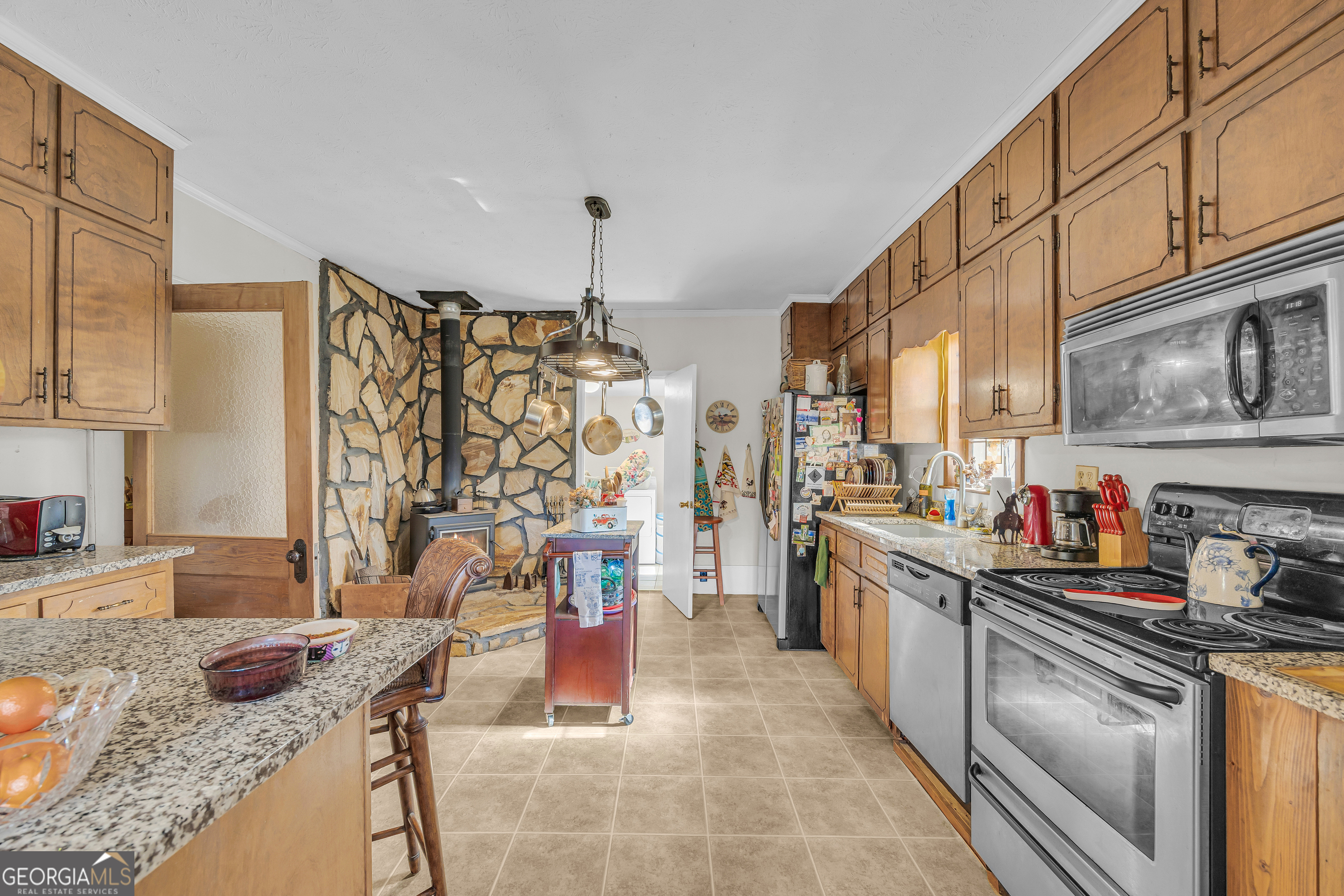 1640 Wire Bridge Road Watkinsville, GA 30677 - Photo 12 of 74 a kitchen with stainless steel appliances granite countertop a sink stove and refrigerator
