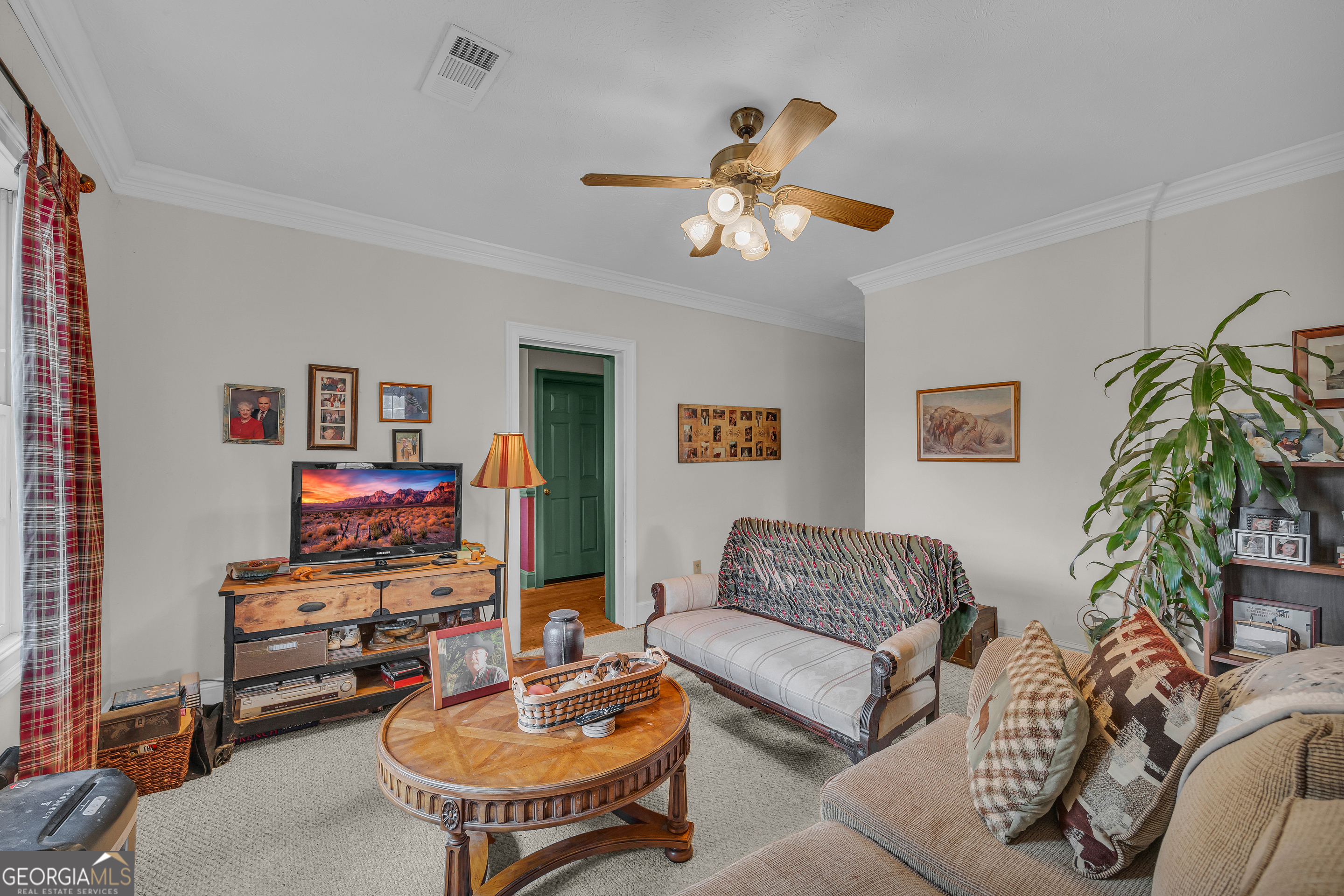 1640 Wire Bridge Road Watkinsville, GA 30677 - Photo 8 of 74 a living room with furniture a chandelier and a flat screen tv