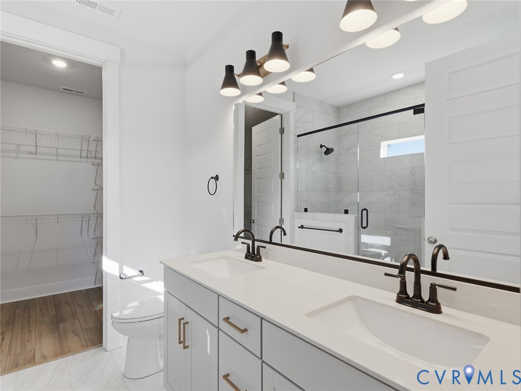 1711 Reed Marsh Lane Goochland, VA 23063 - Photo 11 of 25 a bathroom with a sink a toilet and a mirror