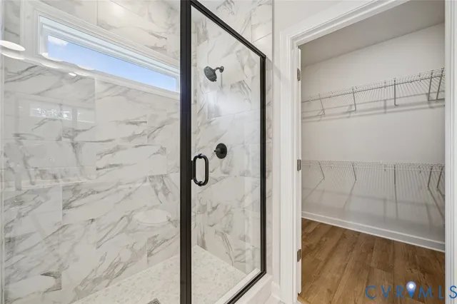 a bathroom with a glass shower door