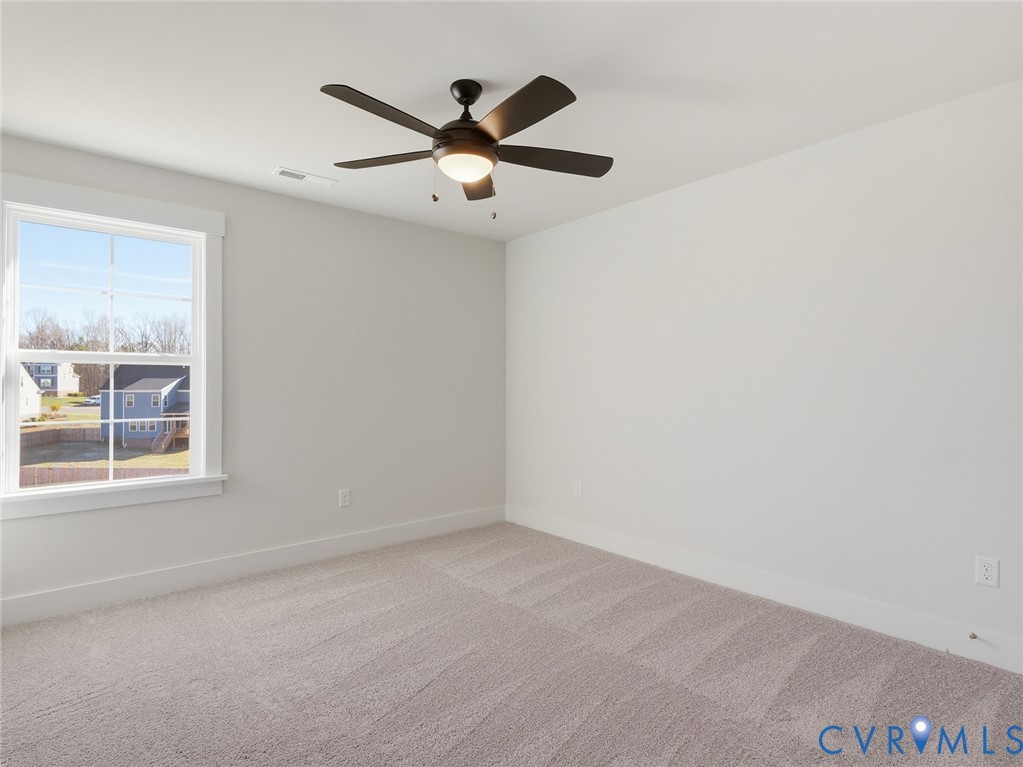 1711 Reed Marsh Lane Goochland, VA 23063 - Photo 17 of 25 an empty room with a window and a fan