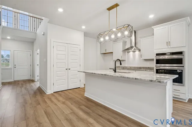 a kitchen with stainless steel appliances granite countertop a sink refrigerator and cabinets