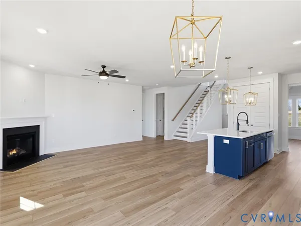 a view of a livingroom with wooden floor and staircase
